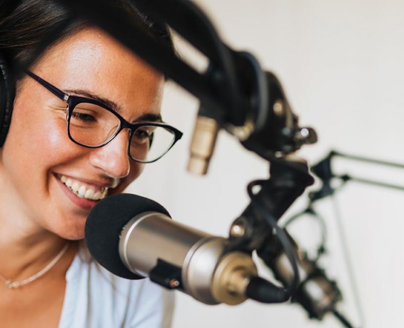 woman behind microphone in studio