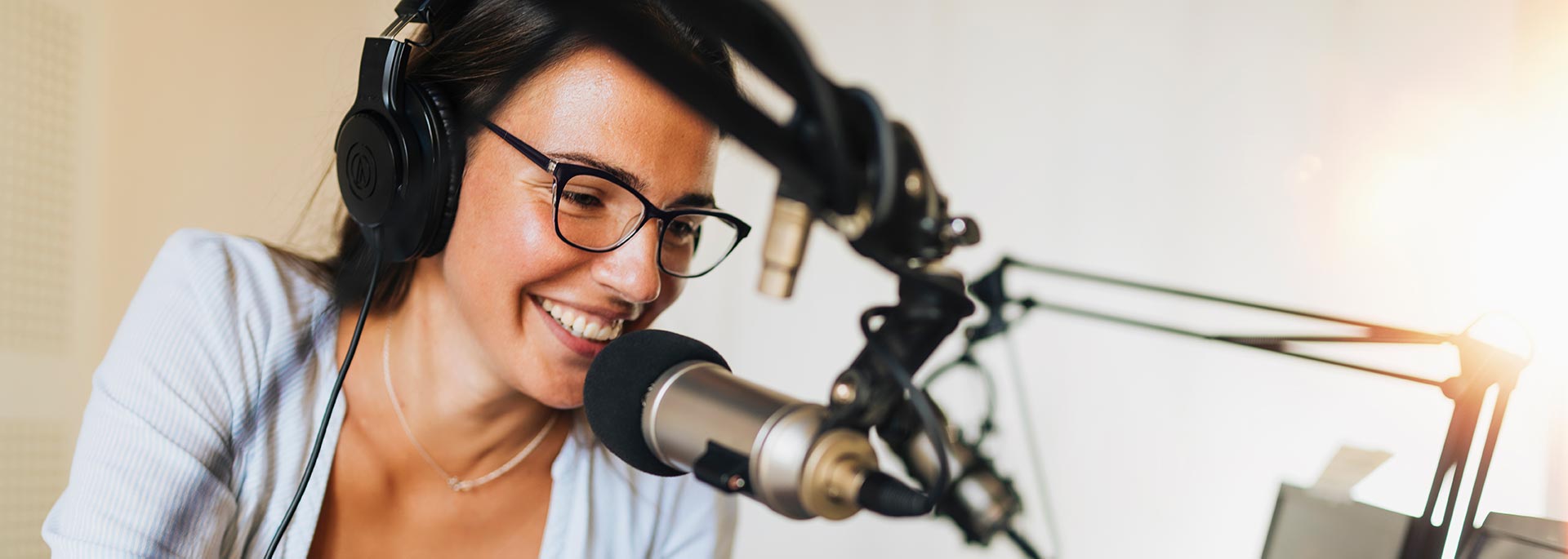 woman behind microphone in studio